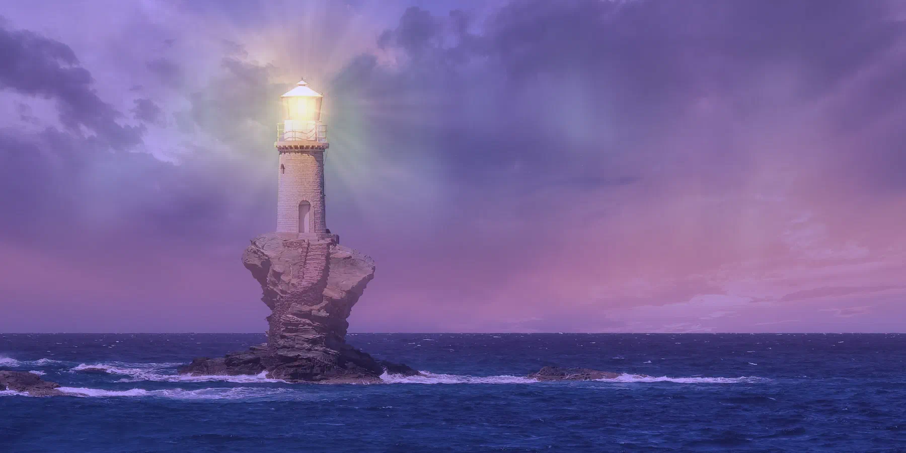 A lighthouse on a rock in the sea, its light breaking through the clouds